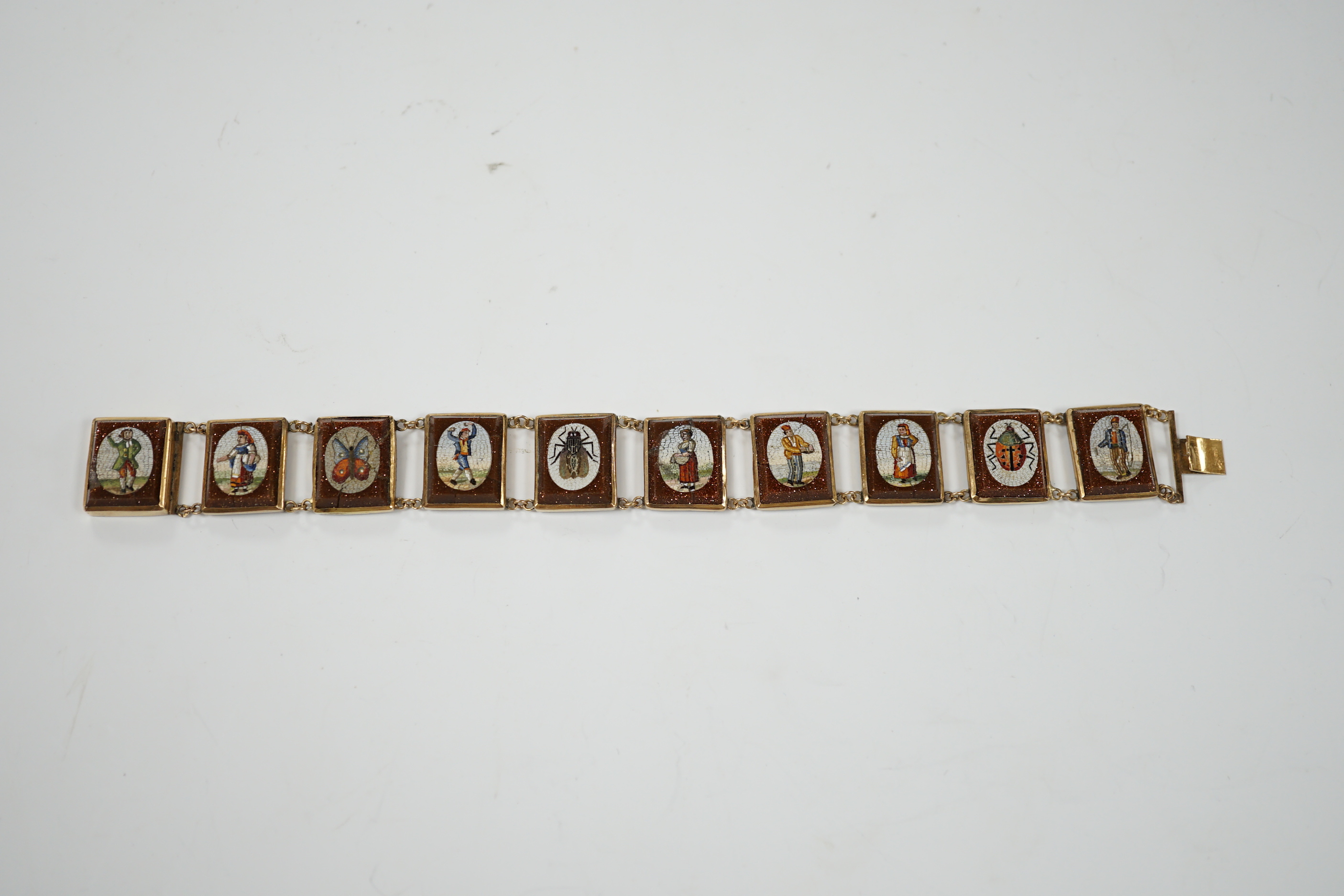 An Italian yellow metal, micro mosaic and goldstone set bracelet, with panels of Italian figures and insects, 17.3cm, gross weight 15.6 grams